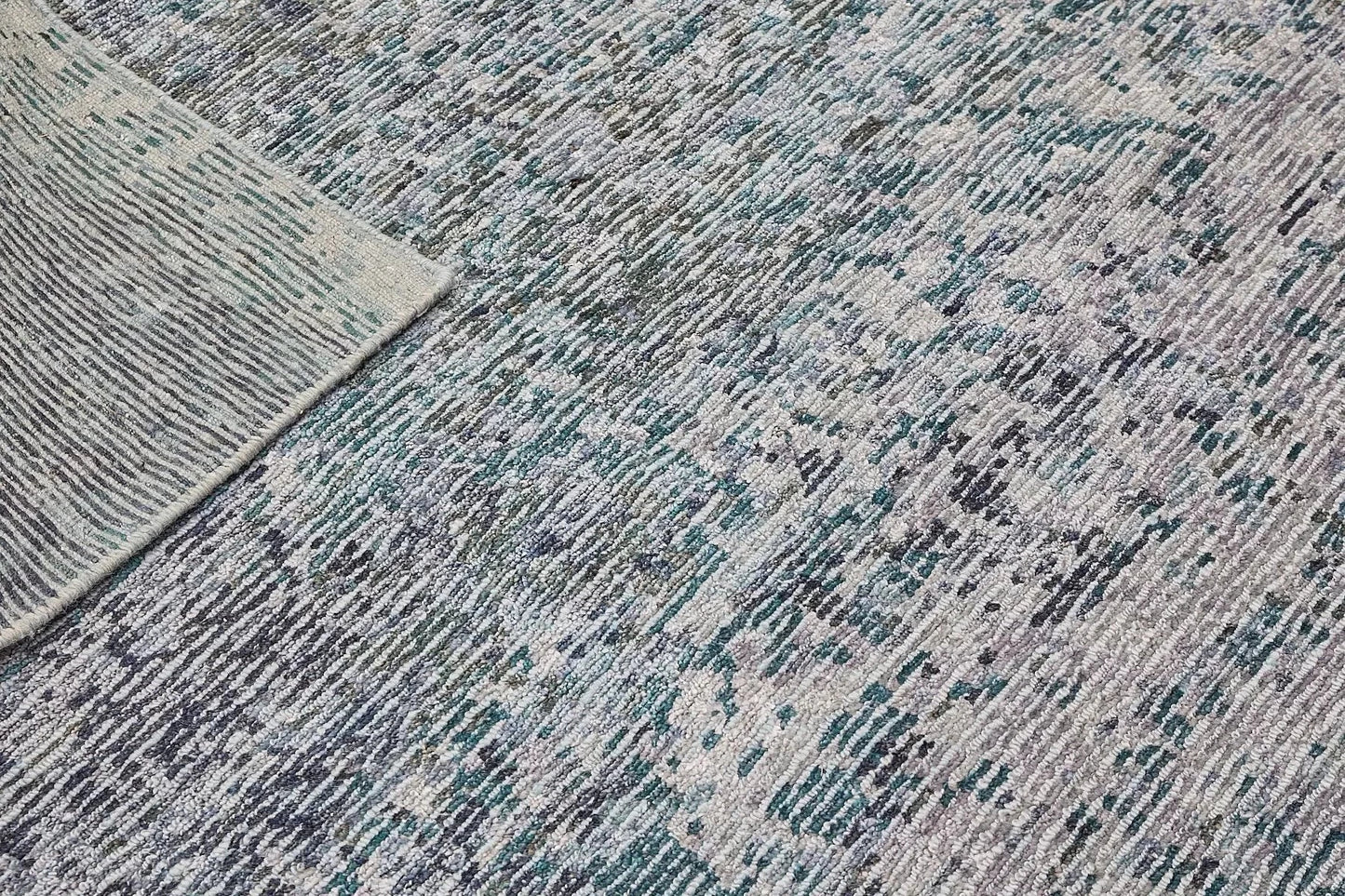 Zurich Teal is a luxurious contemporary/modern designed rug. Hand Knotted from a blend of wool and bamboo Silk. Colours Teal Green, Light Grey, and Grey. Sizes 200 X 290, 250 X 300 and 270 X 360. Fold.