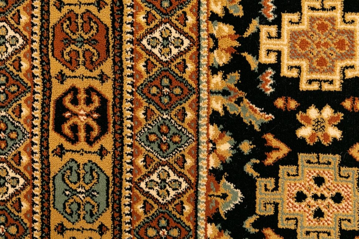 Afghan Black is a machine made rug featuring traditional afghan tribal designs. Made from heat-set polypropylene. Colours Reds, Blacks, and Golds. Sizes. 160 X 235, 200 X 285, 240 X 340 and 300 X 400. Close.