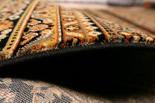 Afghan Black is a machine made rug featuring traditional afghan tribal designs. Made from heat-set polypropylene. Colours Reds, Blacks, and Golds. Sizes. 160 X 235, 200 X 285, 240 X 340 and 300 X 400. Side.