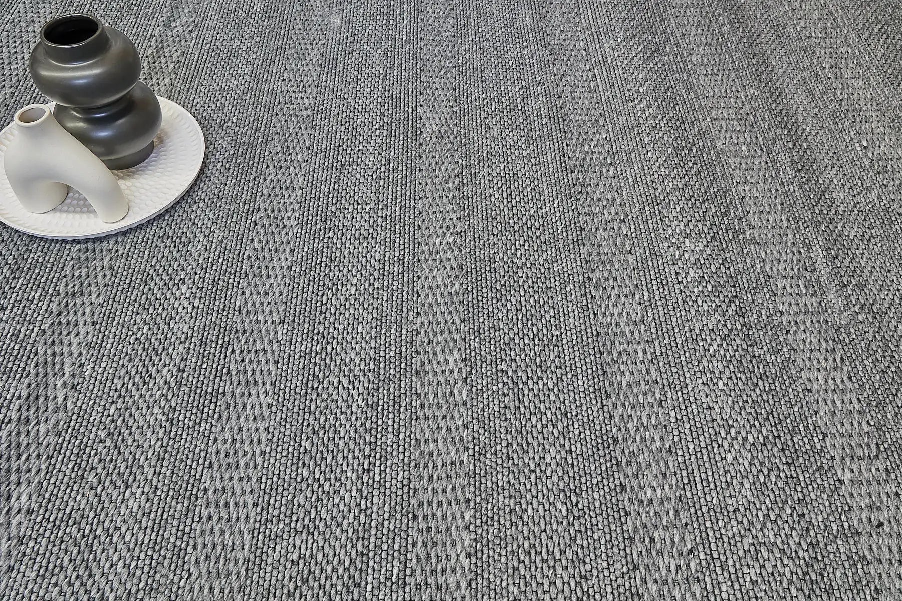 Albi Smoke is a Dark Grey and Black, PET Yarn (recycled Plastic) Hand woven rug. Sizes 160 X 230, 200 X 290 and 240 x 340. Life.
