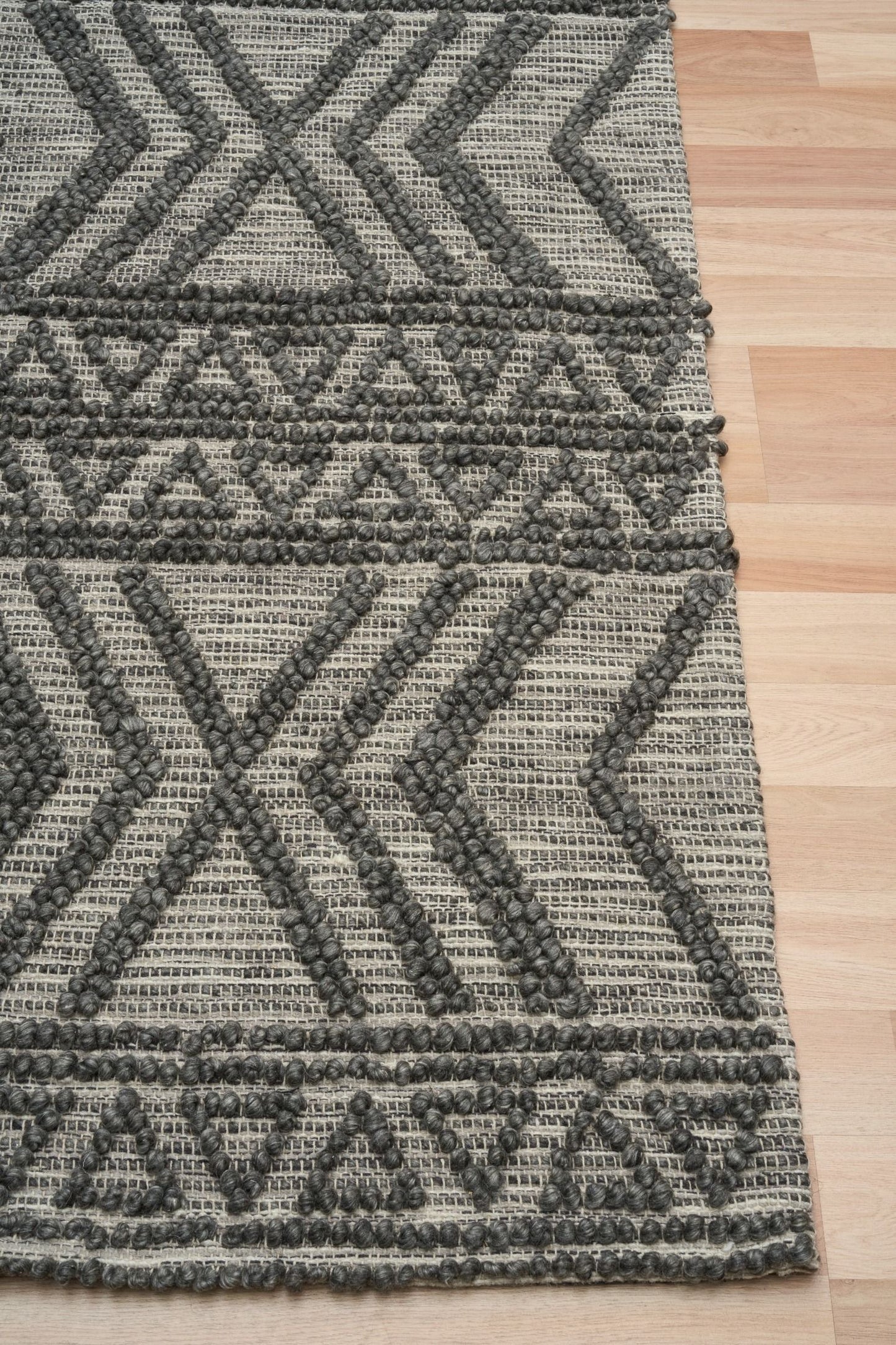 Anita-2 Charcoal is a hand woven textured wool rug. Featuring a tribal geometric design.  Colour Charcoal. Sizes 155 X 225, 200 X 290, 240 X 340 and 300 X 400. Corner.