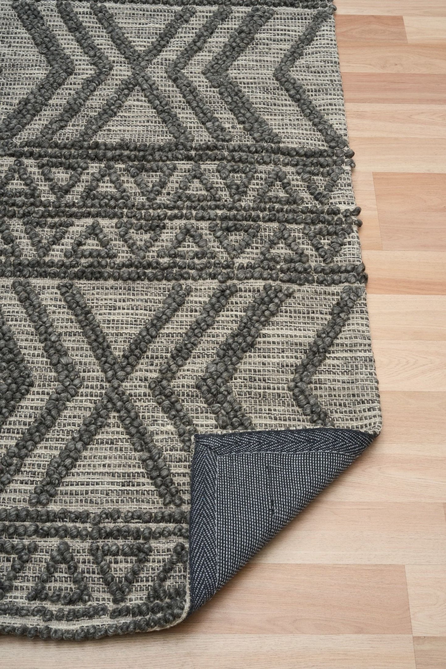 Anita-2 Charcoal is a hand woven textured wool rug. Featuring a tribal geometric design.  Colour Charcoal. Sizes 155 X 225, 200 X 290, 240 X 340 and 300 X 400. Fold.