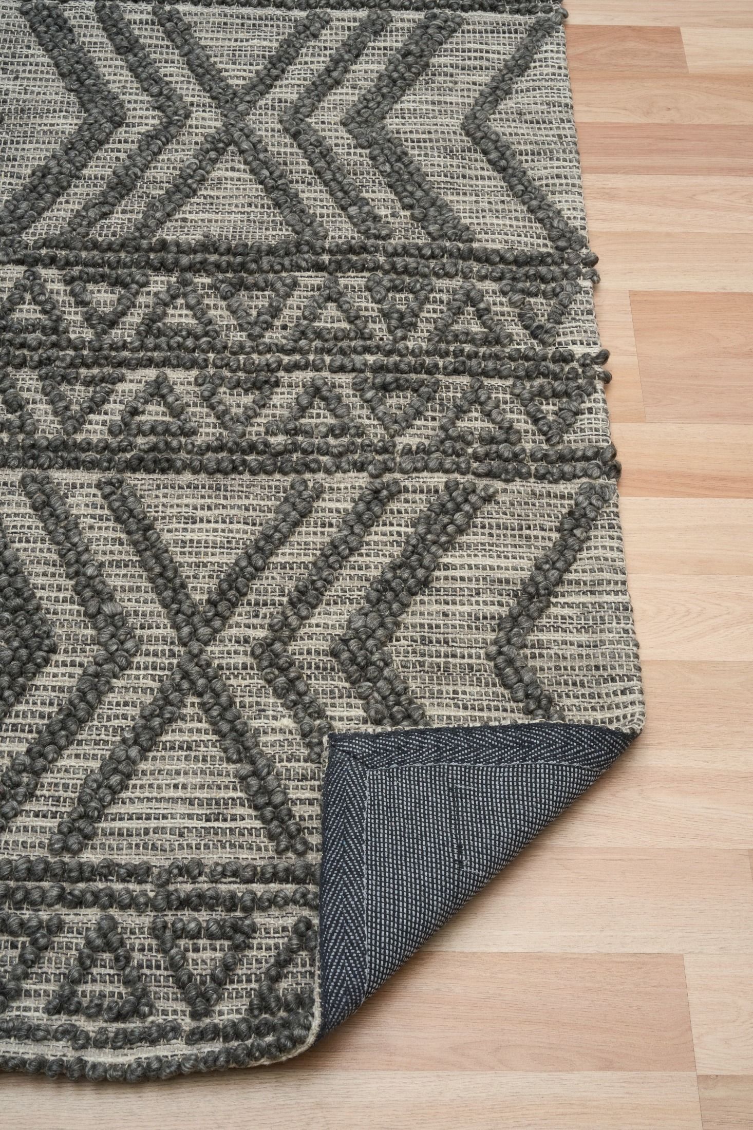 Anita-2 Charcoal is a hand woven textured wool rug. Featuring a tribal geometric design.  Colour Charcoal. Sizes 155 X 225, 200 X 290, 240 X 340 and 300 X 400. Fold.