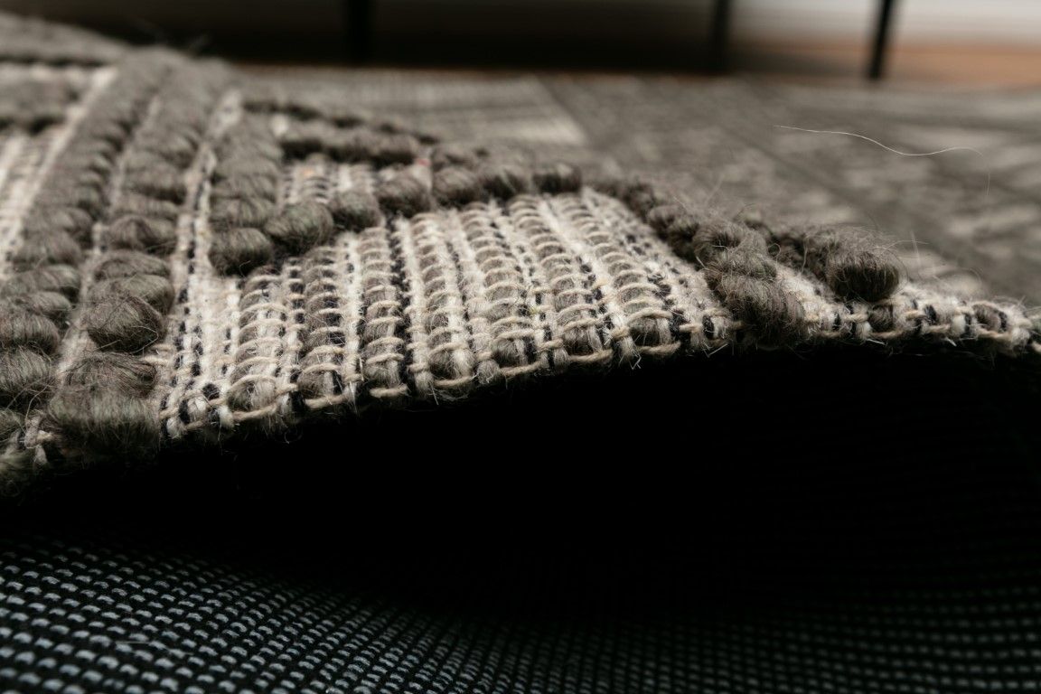 Anita-2 Charcoal is a hand woven textured wool rug. Featuring a tribal geometric design.  Colour Charcoal. Sizes 155 X 225, 200 X 290, 240 X 340 and 300 X 400. Side.