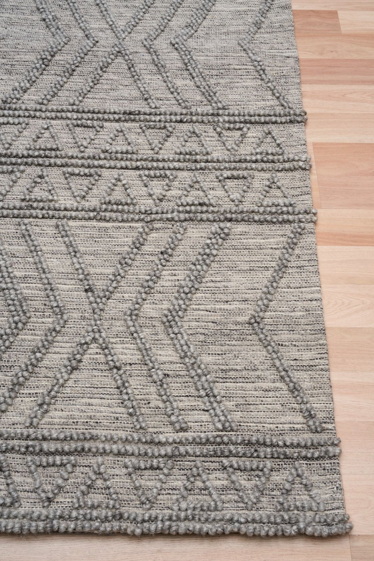 Anita-2 Grey is a hand woven textured wool rug. Featuring a tribal geometric design.  Colour Charcoal. Sizes 155 X 225, 200 X 290, 240 X 340 and 300 X 400. Corner.
