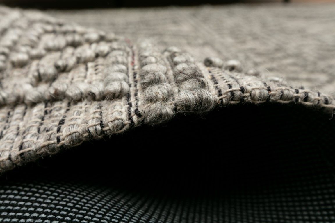 Anita-2 Grey is a hand woven textured wool rug. Featuring a tribal geometric design.  Colour Charcoal. Sizes 155 X 225, 200 X 290, 240 X 340 and 300 X 400. Side.