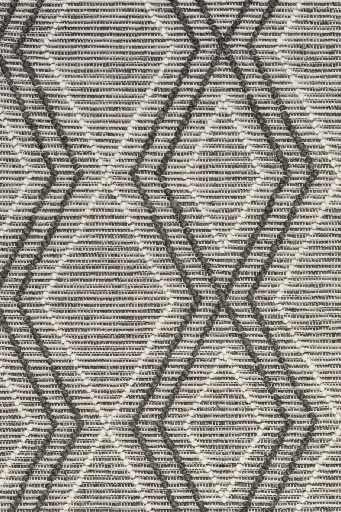 Anita Charcoal is a hand woven textured wool rug. Featuring a tribal geometric design with a 6-8mm pile height.  Colour Charcoal, Grey and White. Sizes 155 X 225, 200 X 290, 240 X 320 and 300 X 400. Close.