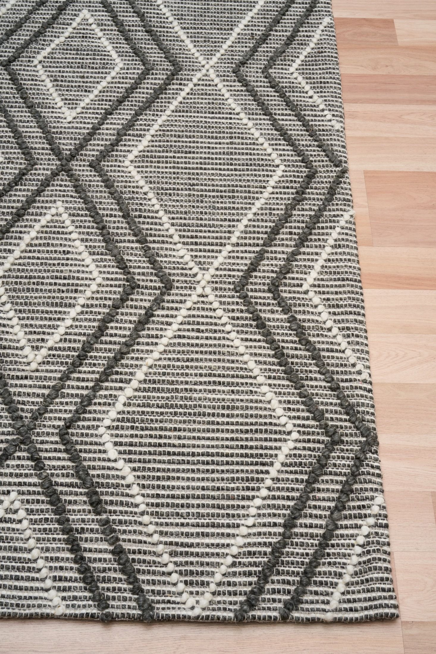 Anita Charcoal is a hand woven textured wool rug. Featuring a tribal geometric design with a 6-8mm pile height.  Colour Charcoal, Grey and White. Sizes 155 X 225, 200 X 290, 240 X 320 and 300 X 400. Corner.