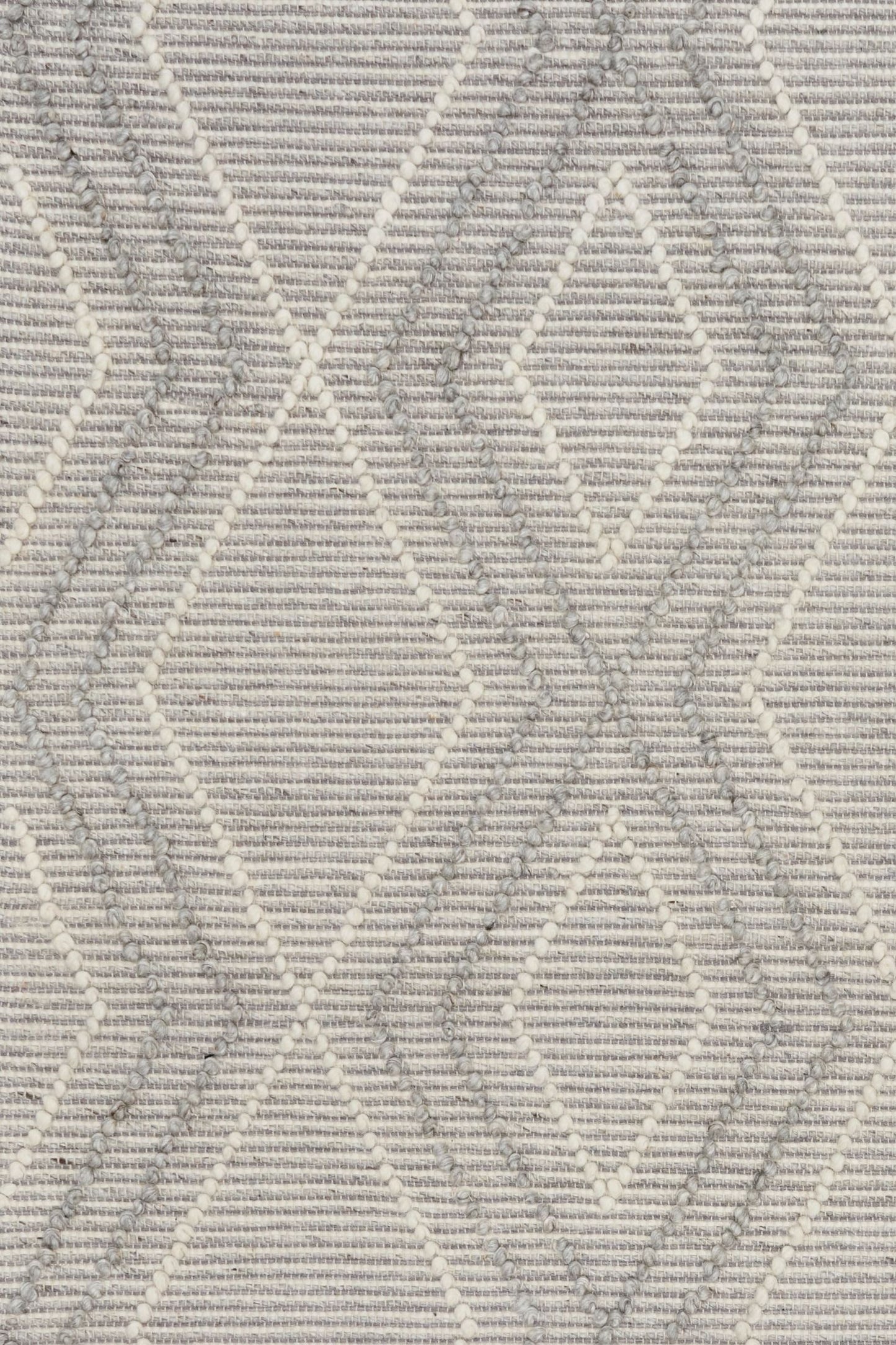 Anita Silver is a hand woven textured wool rug. Featuring a tribal geometric design with a 6-8mm pile height.  Colour Silver Grey, Grey and White. Sizes 155 X 225, 200 X 290, 240 X 320 and 300 X 400. Close.