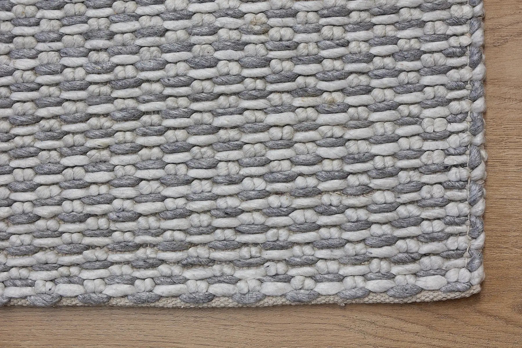 Ankara Grey is a Hand-woven, loop-textured rug crafted from a luxurious combination of wool and bamboo silk. Colours Light Grey and Grey. Sizes 160 X 230, 200 X 290, and 240 X 340. Corner.