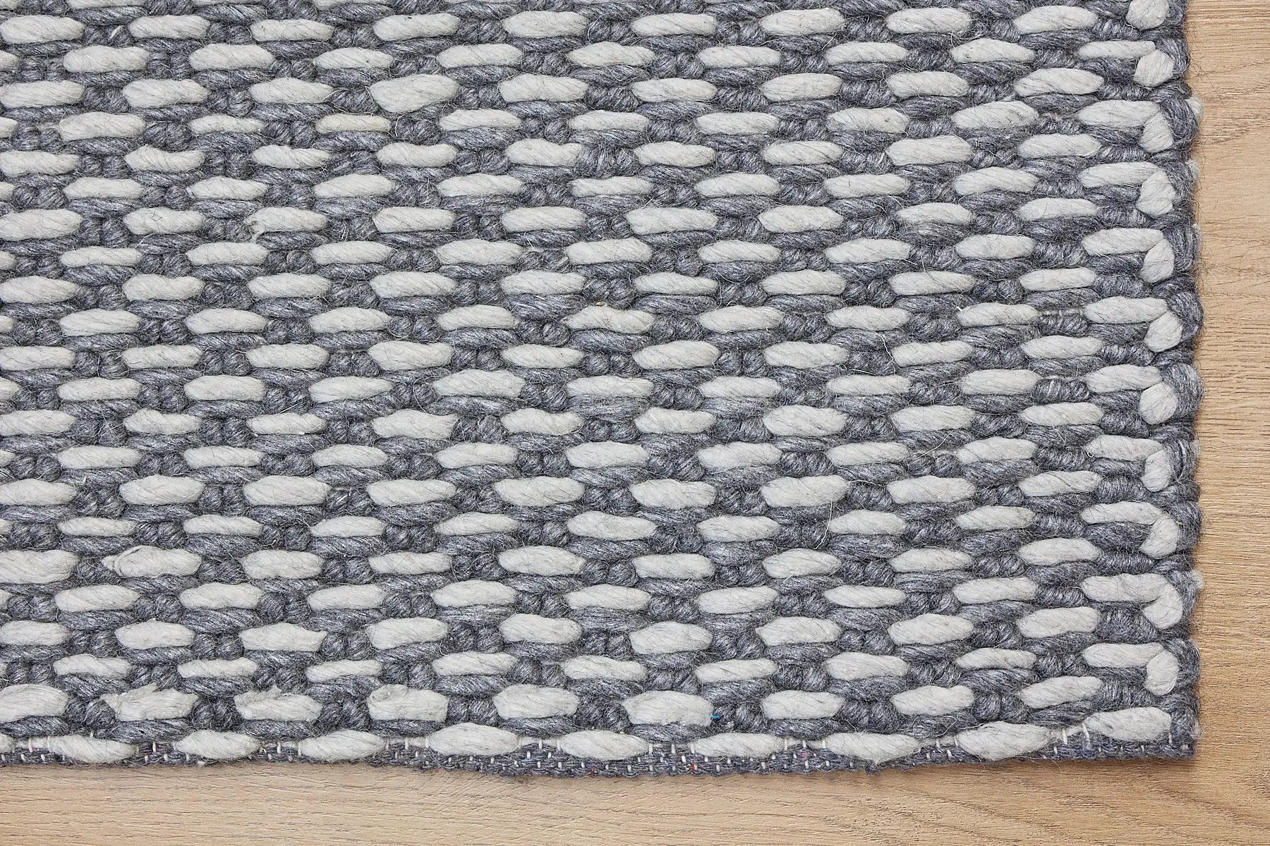 Ankara Smoke is a Hand-woven, loop-textured rug crafted from a luxurious combination of wool and bamboo silk. Colours Dark Grey and Light Grey. Sizes 160 X 230, 200 X 290, and 240 X 340. Corner.