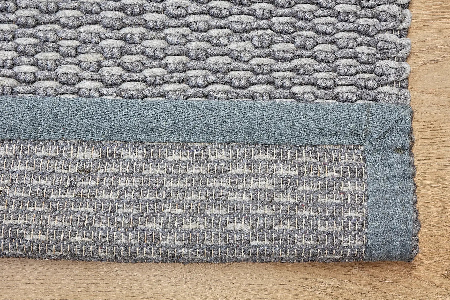 Ankara Stone is a Hand-woven, loop-textured rug crafted from a luxurious combination of wool and bamboo silk. Colours Grey and Light Grey. Sizes 160 X 230, 200 X 290, and 240 X 340. Fold.