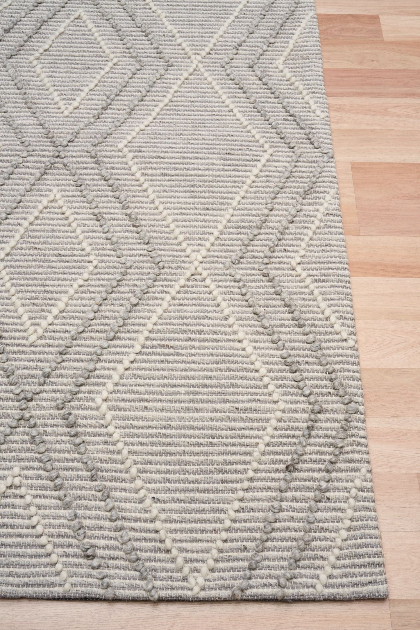Anita Silver is a hand woven textured wool rug. Featuring a tribal geometric design with a 6-8mm pile height.  Colour Silver Grey, Grey and White. Sizes 155 X 225, 200 X 290, 240 X 320 and 300 X 400. Corner.