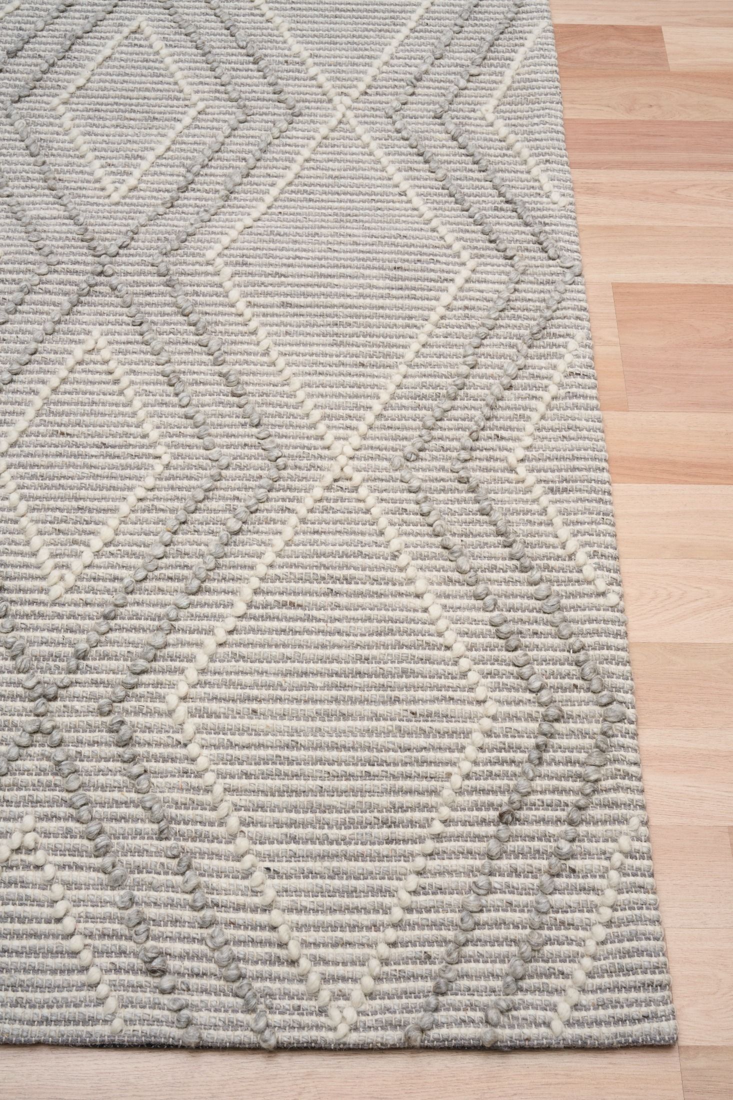 Anita Silver is a hand woven textured wool rug. Featuring a tribal geometric design with a 6-8mm pile height.  Colour Silver Grey, Grey and White. Sizes 155 X 225, 200 X 290, 240 X 320 and 300 X 400. Corner.