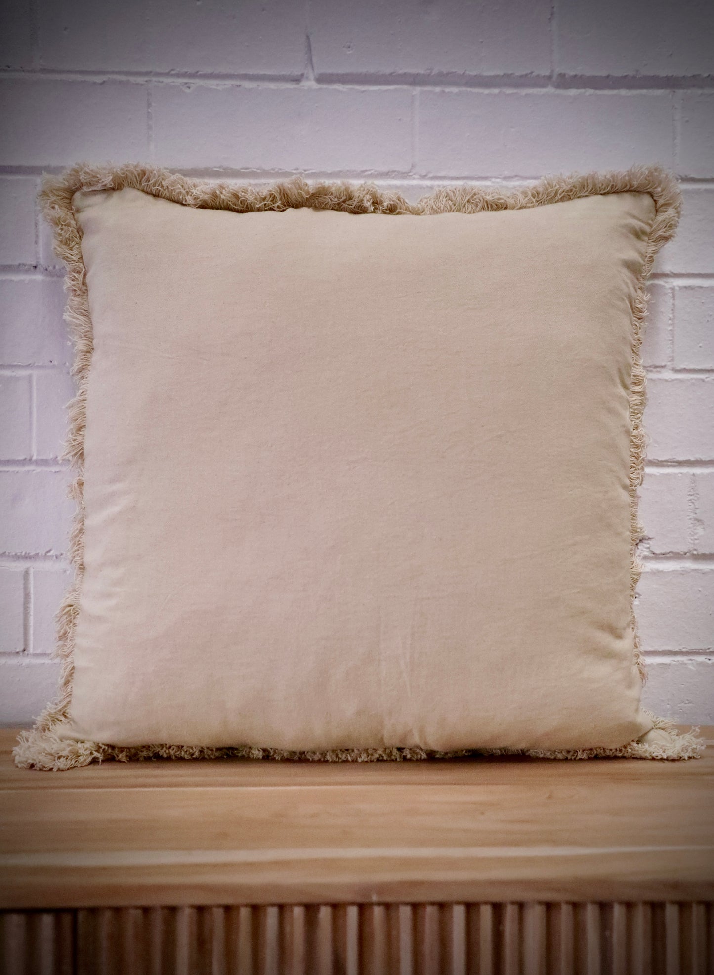 Our Antique Cream, cushion is hand crafted in India by skilled artisans. Features a soft feel, with small fringes around the edges. Colour Cream. Sizes 50 X 50 and 60 X 60. Front.