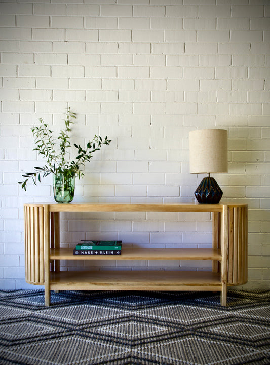 The Aries Low bookshelf is a coastal/contemporary designed piece. It features curved slated sides and and 3 shelves. Made from sustainable bleached fruitwood. Colour Natural. Measuring 1500 length X 350 depth X 650 height. Front Styled.