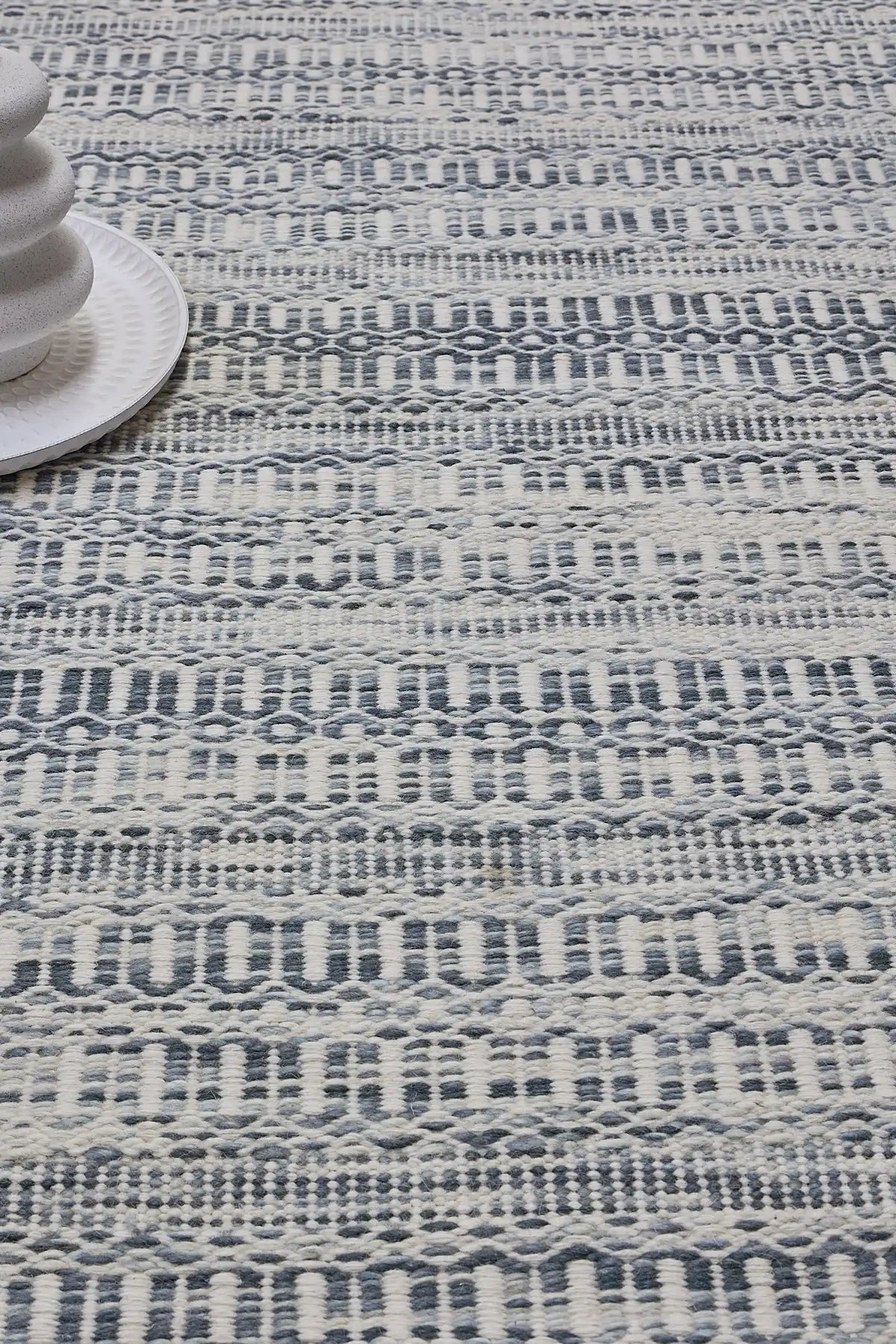 Arizona Alloy is a Hand Woven Wool Flatweave. With a Geometric Tribal Design. Colour White with Blue accents. Sizes, 160 X 230, 200 X 290 and 240 X 340. Life 