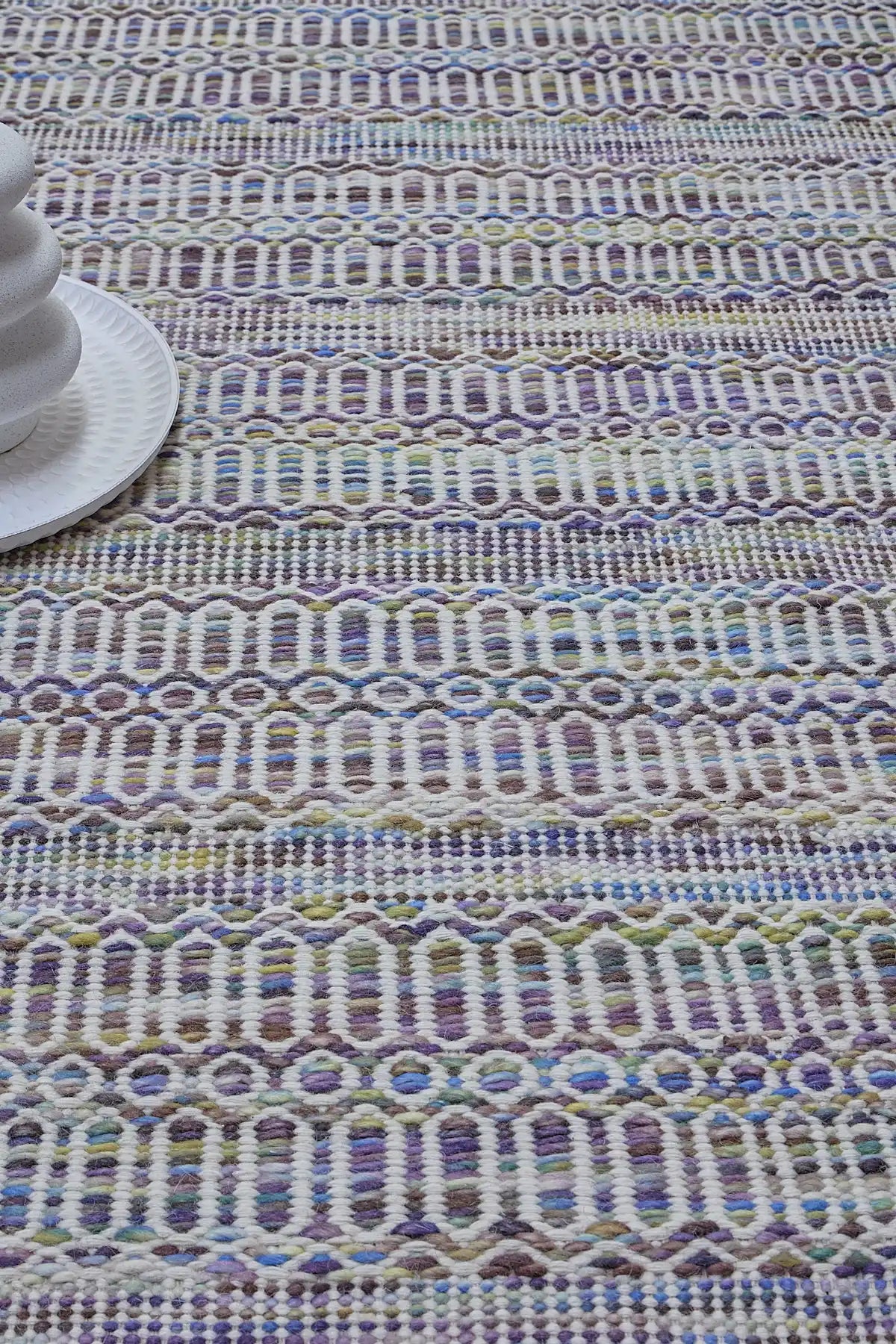 Arizona - Lavender is a Hand Woven Wool Flatweave. With a Geometric Tribal Design. Colour White and Lavender with Multi coloured accents. Sizes, 160 X 230, 200 X 290 and 240 X 340. Life 
