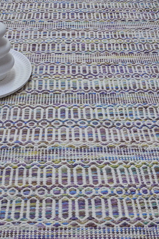 Arizona - Lavender is a Hand Woven Wool Flatweave. With a Geometric Tribal Design. Colour White and Lavender with Multi coloured accents. Sizes, 160 X 230, 200 X 290 and 240 X 340. Life 