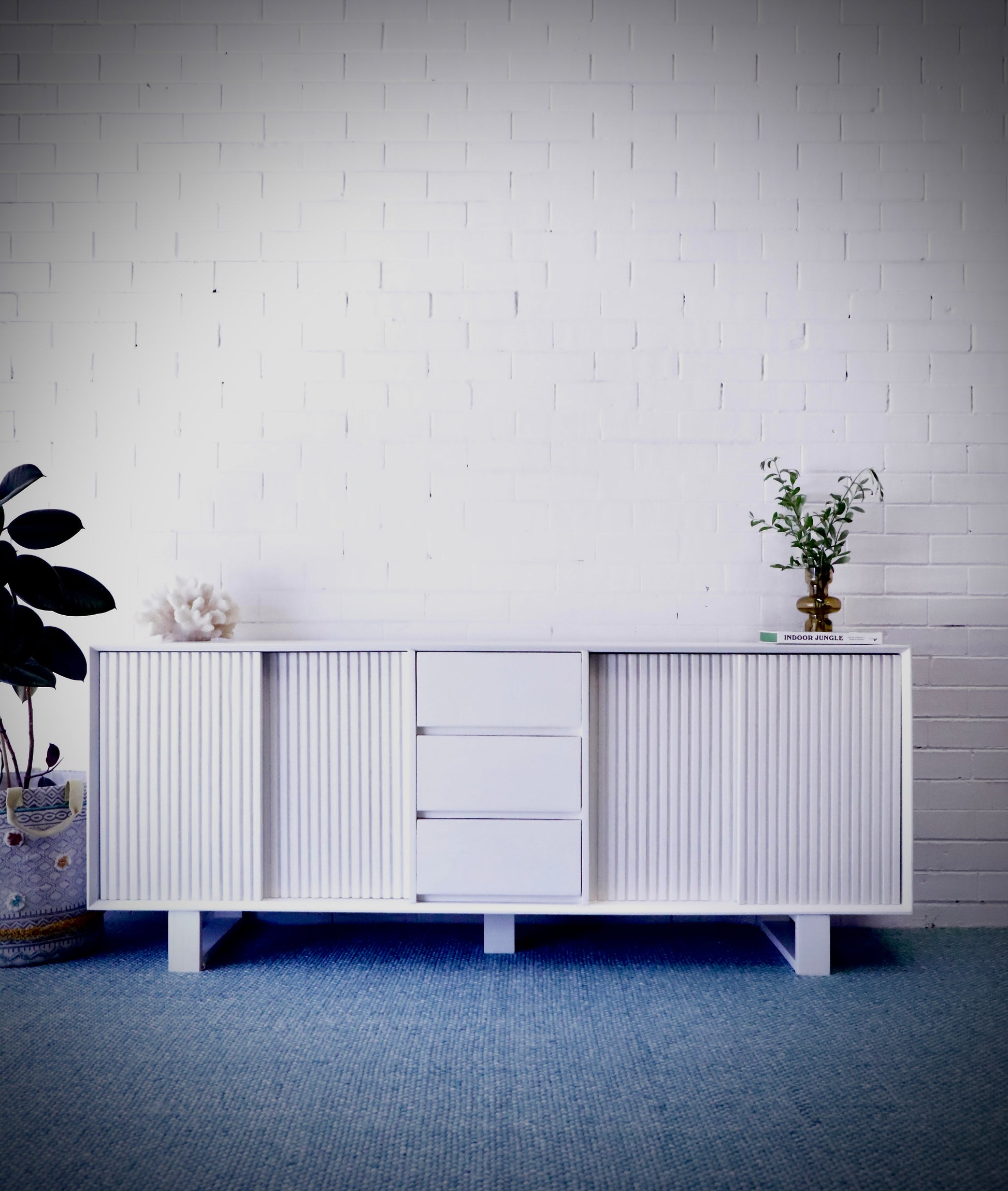 The Ashland 2 Sliding Door 3 Drawer - White Buffet - a Coastal Contemporary Teak Buffet. Featuring 2 sliding doors, and 3 drawers, supported by wooden runners. Measures 1800 Length X 400 Depth X 900 Height. Styled.