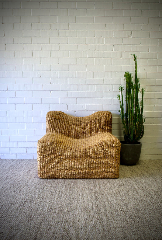 The Aster Occasional Chair is an indoor/outdoor lounge chair crafted from banana leaf.  Colour Natural Brown. Measures 860 wide X 850 depth X 680 height. Front Styled.