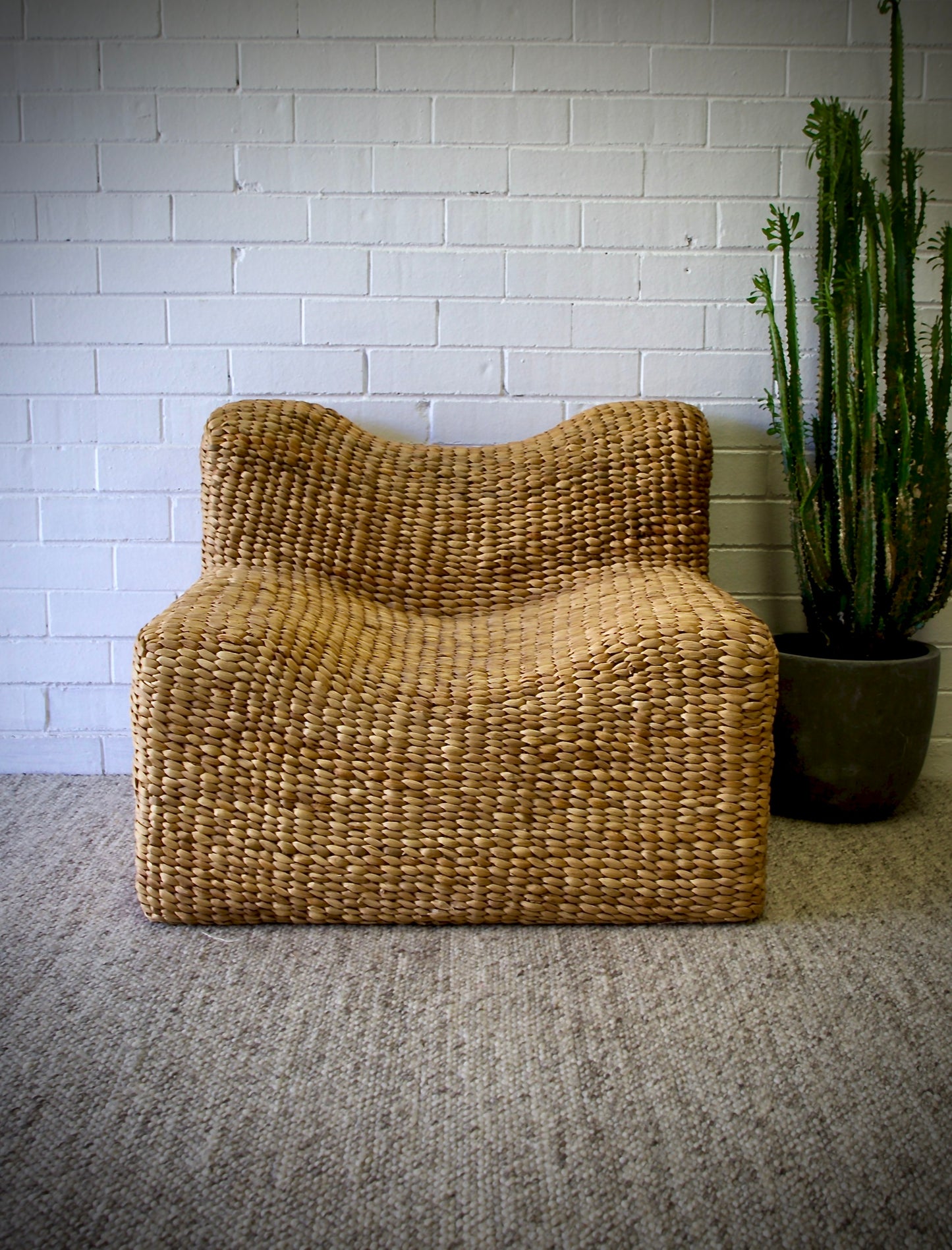 The Aster Occasional Chair is an indoor/outdoor lounge chair crafted from banana leaf.  Colour Natural Brown. Measures 800 Wide x 820 Depth x 650 Height. Front Styled.