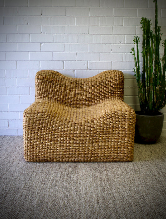 The Aster Occasional Chair is an indoor/outdoor lounge chair crafted from banana leaf.  Colour Natural Brown. Measures 800 Wide x 820 Depth x 650 Height. Front Styled.