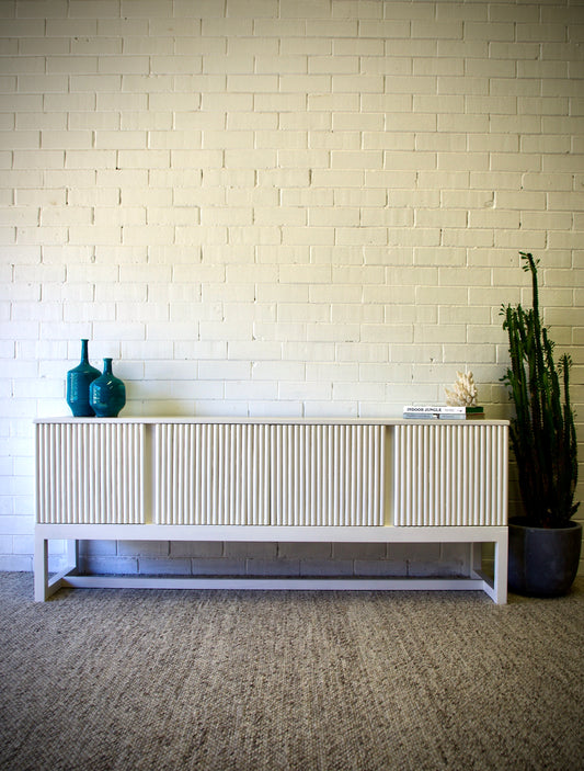 The Astoria 4 Door White buffet is a contemporary styled piece. Crafted from sustainable white cedar, it features 4 textured doors. Colour White. Measures 1800 length X 400 depth X 700 height. Front Styled.