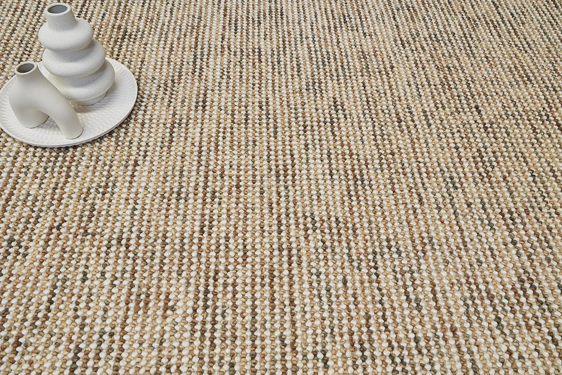 Avila - Beige is a handwoven loop piled carpet. It features a blend of fine wool and viscose, with a pile height of 16-18mm. Colours Beige with Brown accents. Sizes 160 X 230, 200 X 290 and 240 X 340. Life
