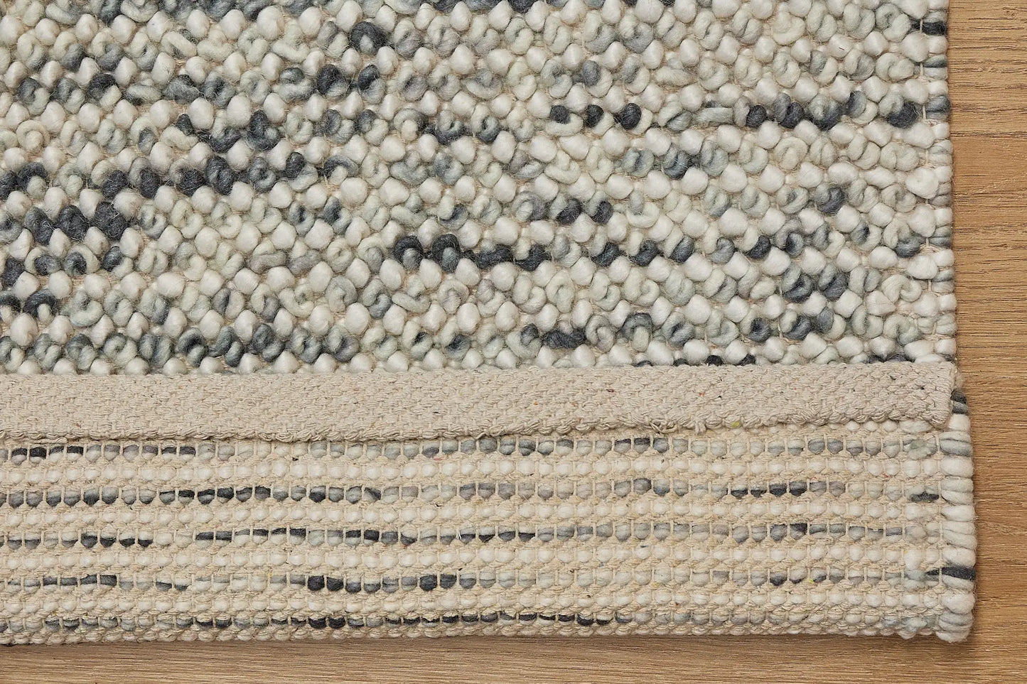 Avila - Forrest is a handwoven loop piled carpet. It features a blend of fine wool and viscose, with a pile height of 16-18mm. Colours White with Forrest Green accents. Sizes 160 X 230, 200 X 290 and 240 X 340. Fold.