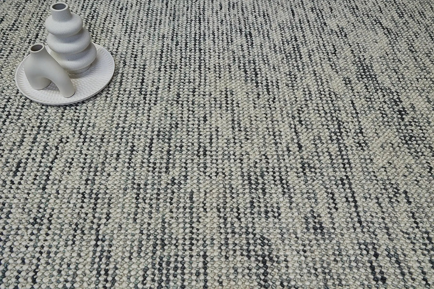 Avila - Forrest is a handwoven loop piled carpet. It features a blend of fine wool and viscose, with a pile height of 16-18mm. Colours White with Forrest Green accents. Sizes 160 X 230, 200 X 290 and 240 X 340. Life