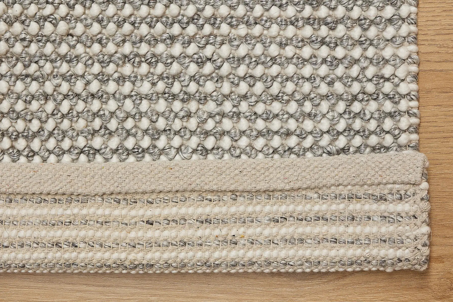 Avila - Grey is a handwoven loop piled carpet. It features a blend of fine wool and viscose, with a pile height of 16-18mm. Colours Light Grey with Dark Grey accents. Sizes 160 X 230, 200 X 290 and 240 X 340. Fold