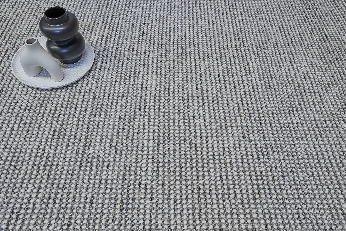 Avila - Grey is a handwoven loop piled carpet. It features a blend of fine wool and viscose, with a pile height of 16-18mm. Colours Light Grey with Dark Grey accents. Sizes 160 X 230, 200 X 290 and 240 X 340. Life