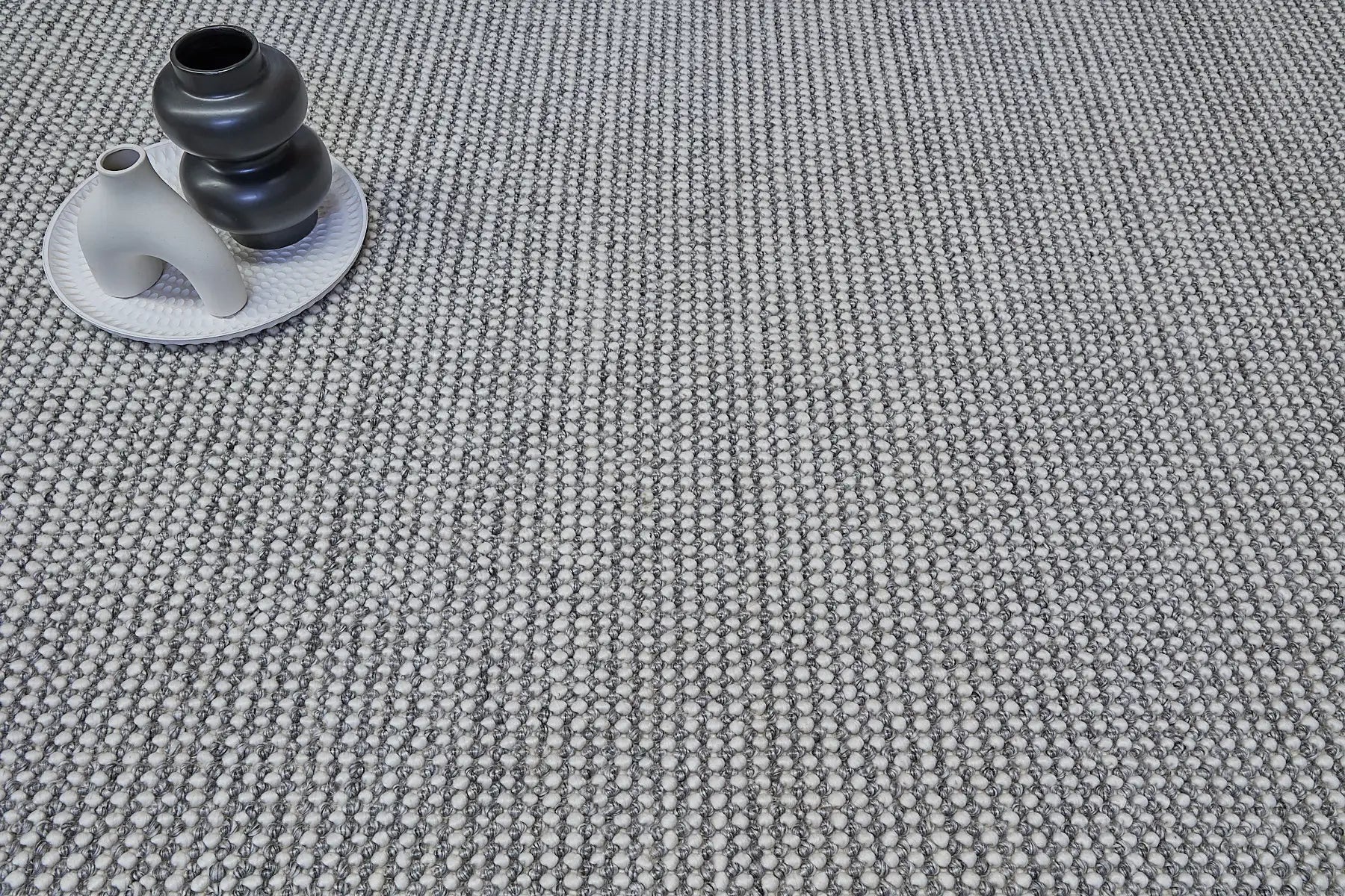 Avila - Grey is a handwoven loop piled carpet. It features a blend of fine wool and viscose, with a pile height of 16-18mm. Colours Light Grey with Dark Grey accents. Sizes 160 X 230, 200 X 290 and 240 X 340. Life