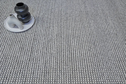 Avila - Grey is a handwoven loop piled carpet. It features a blend of fine wool and viscose, with a pile height of 16-18mm. Colours Light Grey with Dark Grey accents. Sizes 160 X 230, 200 X 290 and 240 X 340. Life