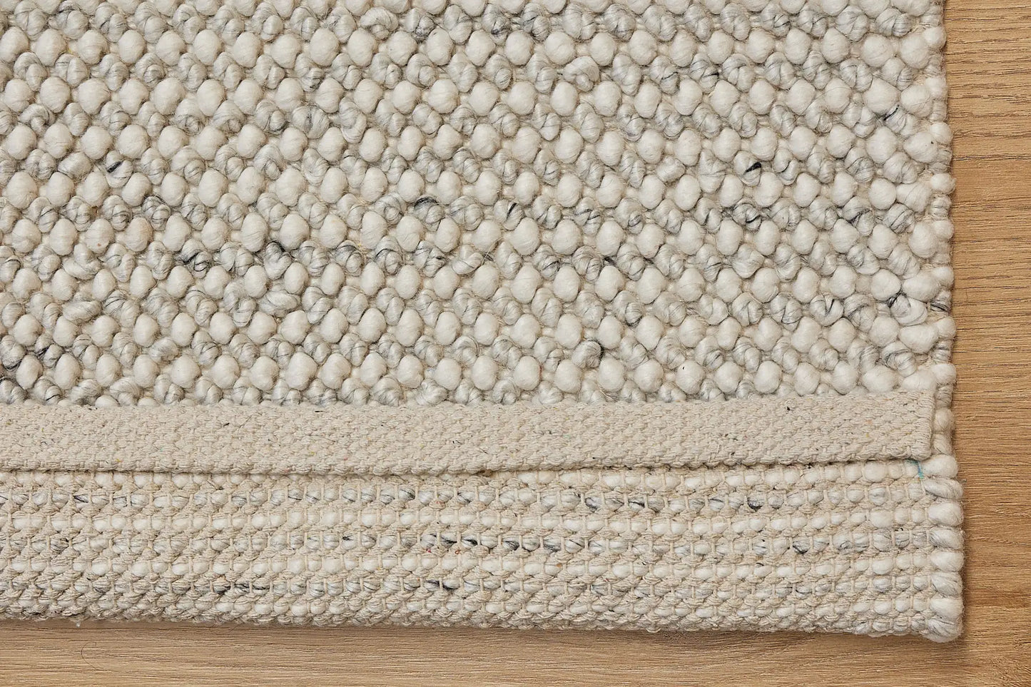 Avila - Natural is a handwoven loop piled carpet. It features a blend of fine wool and viscose, with a pile height of 16-18mm. Colours Cream with Brown and Beige accents. Sizes 160 X 230, 200 X 290 and 240 X 340. Fold.