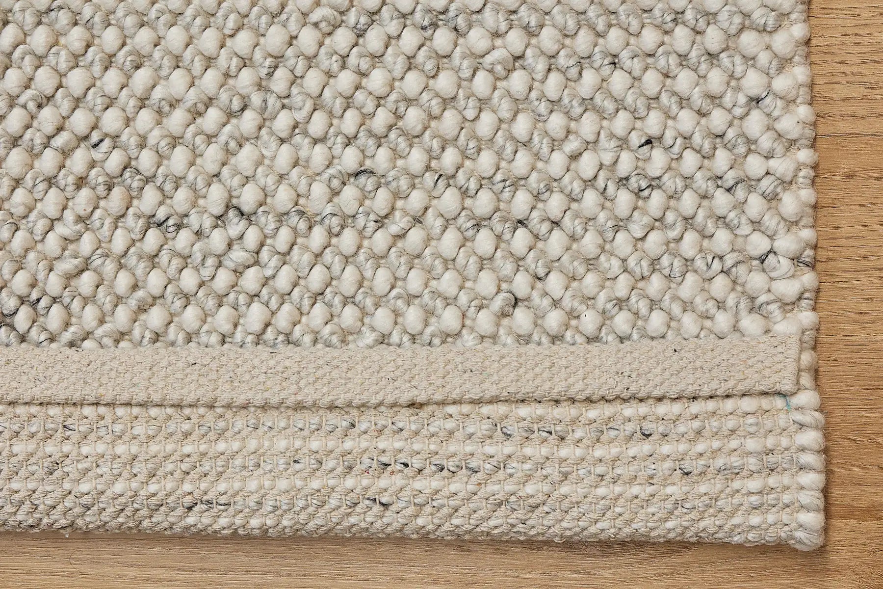 Avila - Natural is a handwoven loop piled carpet. It features a blend of fine wool and viscose, with a pile height of 16-18mm. Colours Cream with Brown and Beige accents. Sizes 160 X 230, 200 X 290 and 240 X 340. Fold.