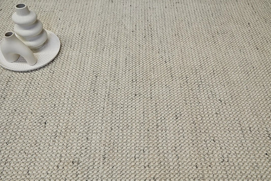 Avila - Natural is a handwoven loop piled carpet. It features a blend of fine wool and viscose, with a pile height of 16-18mm. Colours Cream with Brown and Beige accents. Sizes 160 X 230, 200 X 290 and 240 X 340. Life