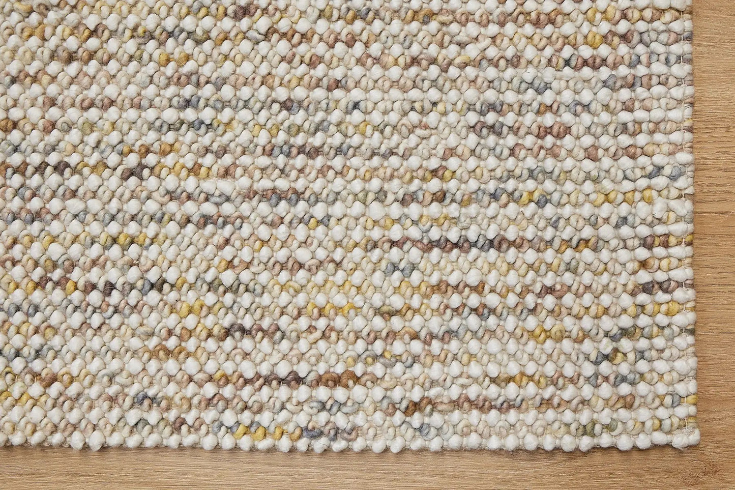 Avila - Sand is a handwoven loop piled carpet. It features a blend of fine wool and viscose, with a pile height of 16-18mm. Colours Cream with Brown, Beiege and Yellow accents. Sizes 160 X 230, 200 X 290 and 240 X 340. Corner.