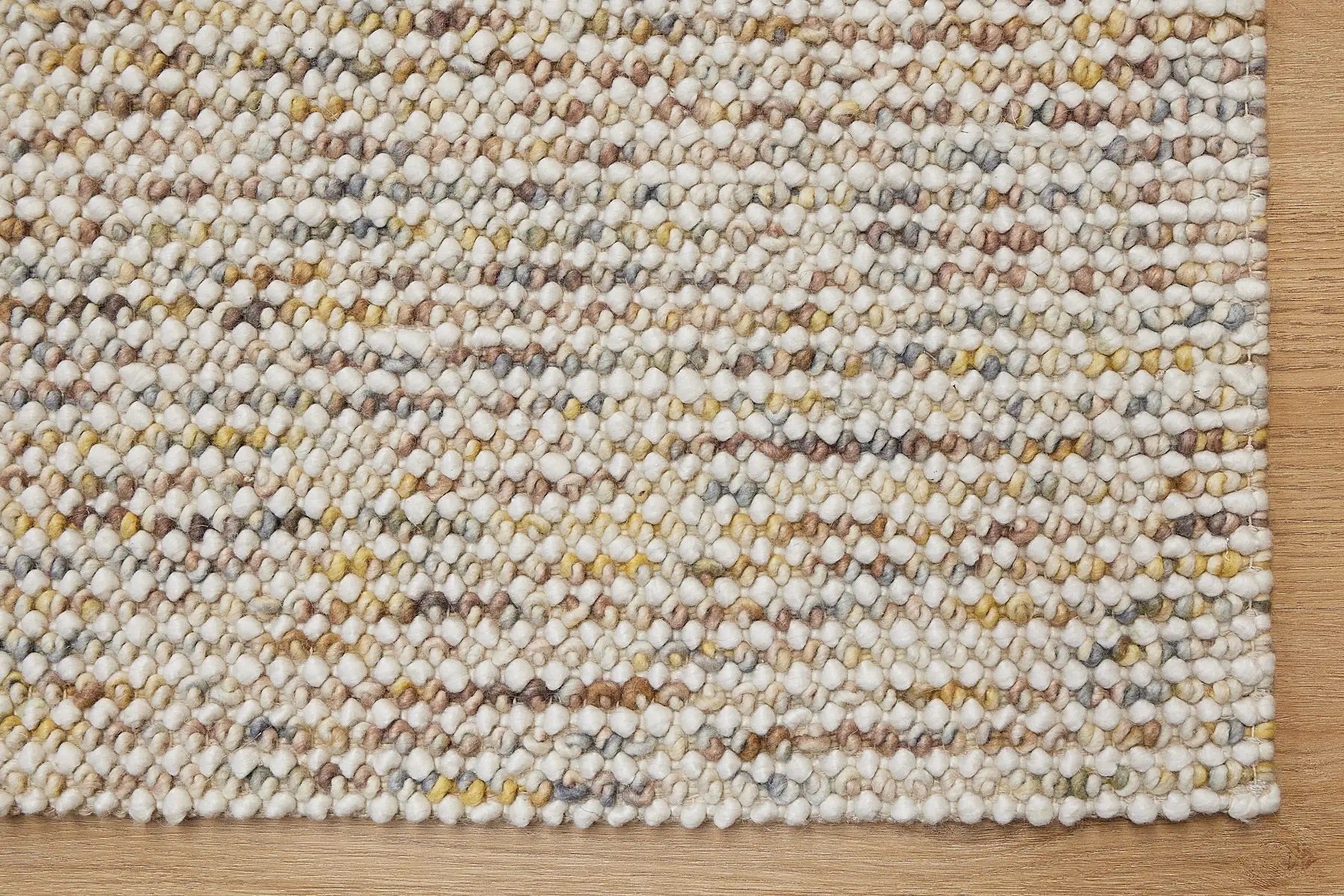 Avila - Sand is a handwoven loop piled carpet. It features a blend of fine wool and viscose, with a pile height of 16-18mm. Colours Cream with Brown, Beiege and Yellow accents. Sizes 160 X 230, 200 X 290 and 240 X 340. Corner.