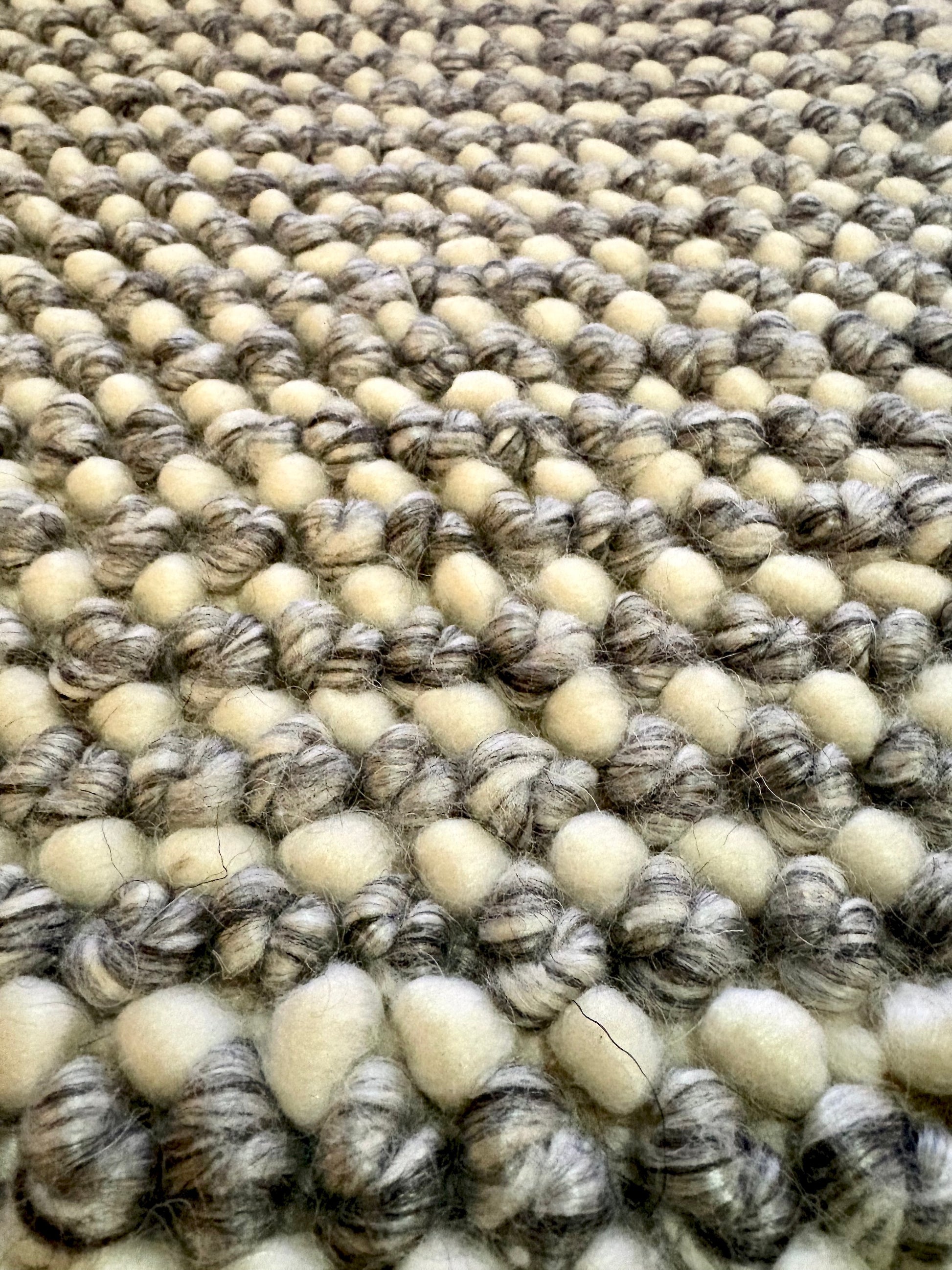 Avila - Grey is a handwoven loop piled carpet. It features a blend of fine wool and viscose, with a pile height of 16-18mm. Colours Light Grey with Dark Grey accents. Sizes 160 X 230, 200 X 290, 240 X 340 and 300 X 400. Close.