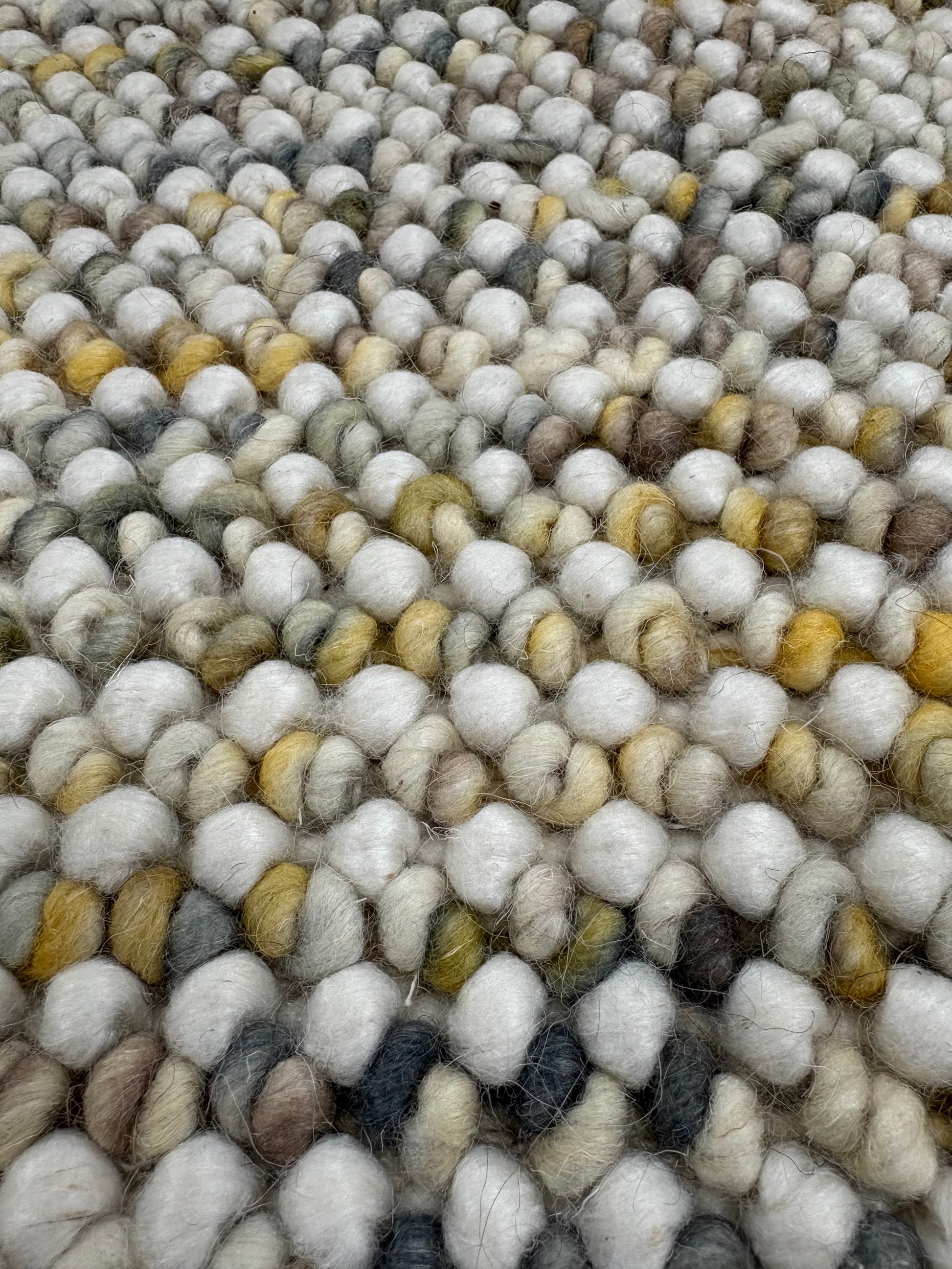 Avila - Sand is a handwoven loop piled carpet. It features a blend of fine wool and viscose, with a pile height of 16-18mm. Colours Cream with Brown, Beige and Yellow accents. Sizes 160 X 230, 200 X 290, 240 X 340 and 300 X 400. Close.