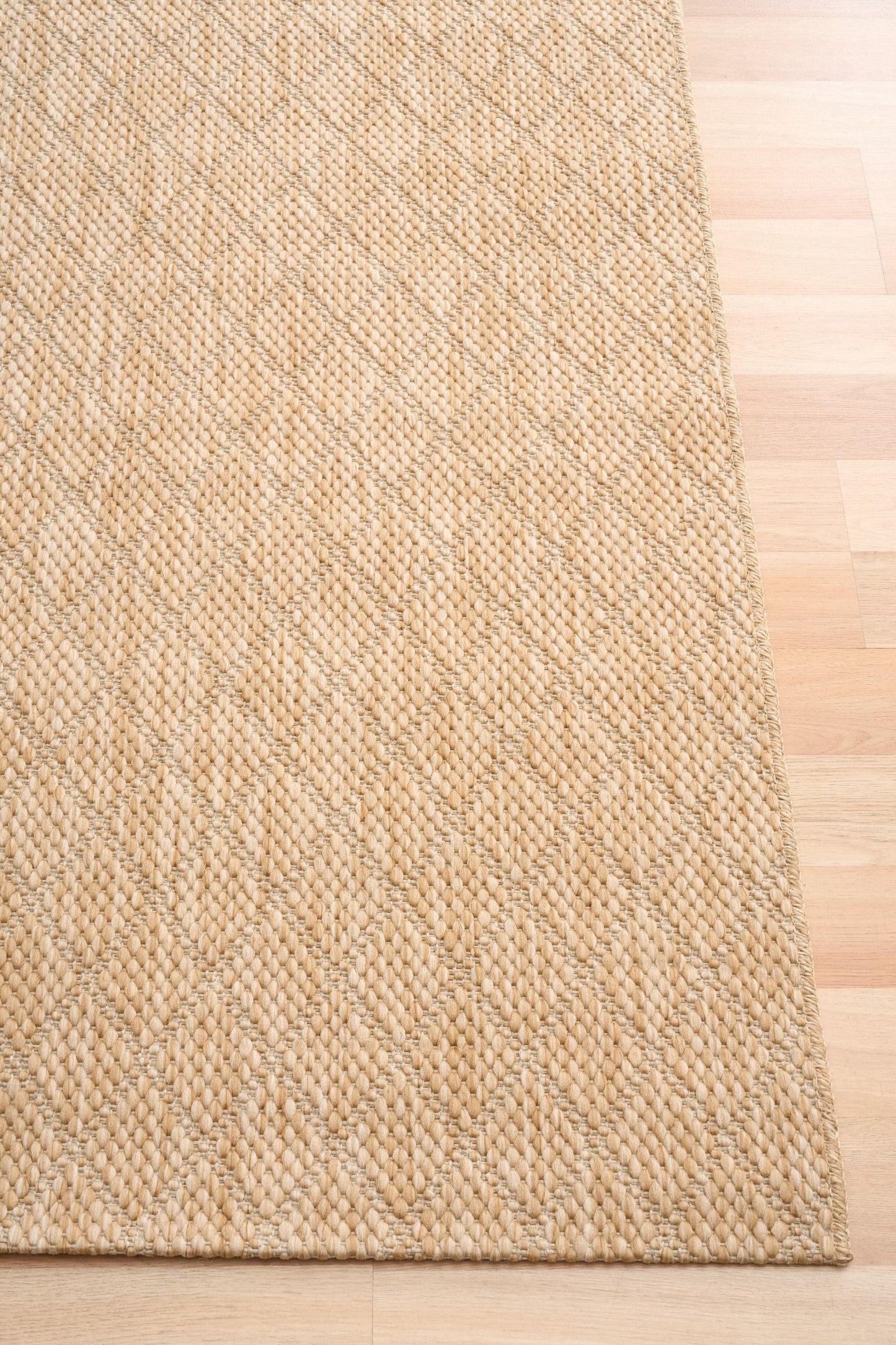 Barton Beige 41512 indoor/outdoor rug featuring soft beige tones and a subtle textured pattern, power-loomed from UV-stabilised polypropylene for lasting durability. Colour Beige. 3 sizes. Corner.