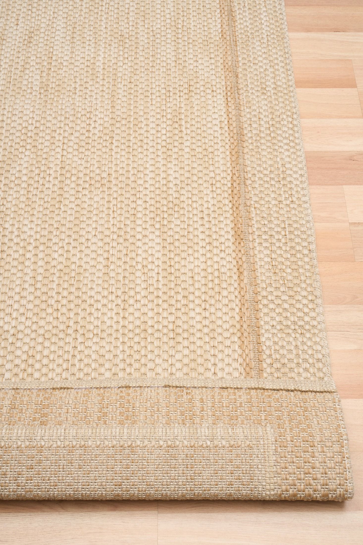 Barton Cream 41505 indoor/outdoor rug featuring soft cream tones and a subtle textured pattern, power-loomed from UV-stabilised polypropylene for lasting durability. Colour Cream. 3 sizes. Fold.