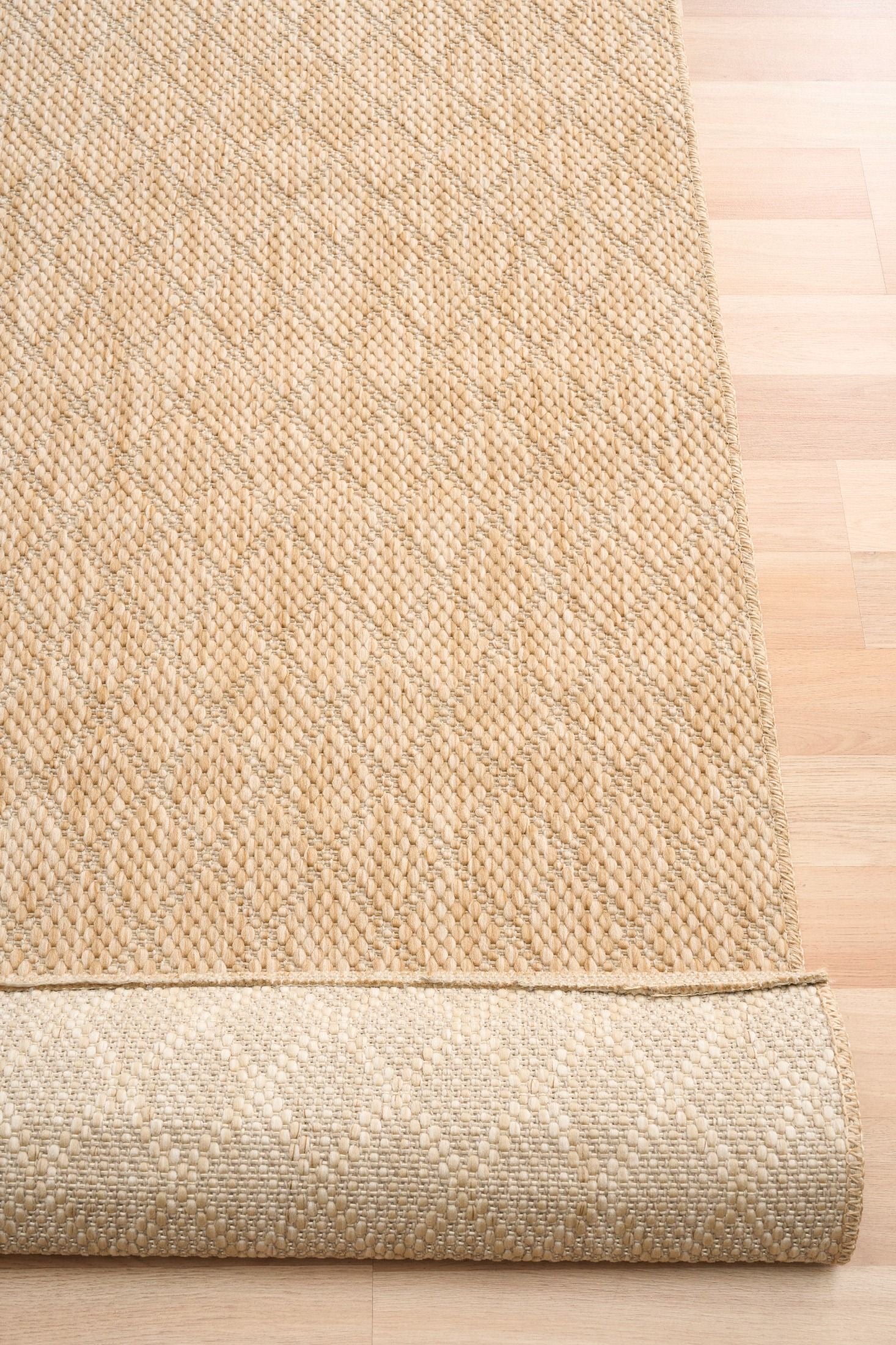 Barton Diamond Beige indoor/outdoor rug featuring soft beige tones and a subtle textured pattern, power-loomed from UV-stabilised polypropylene for lasting durability. Colour Beige. 3 sizes. Fold.