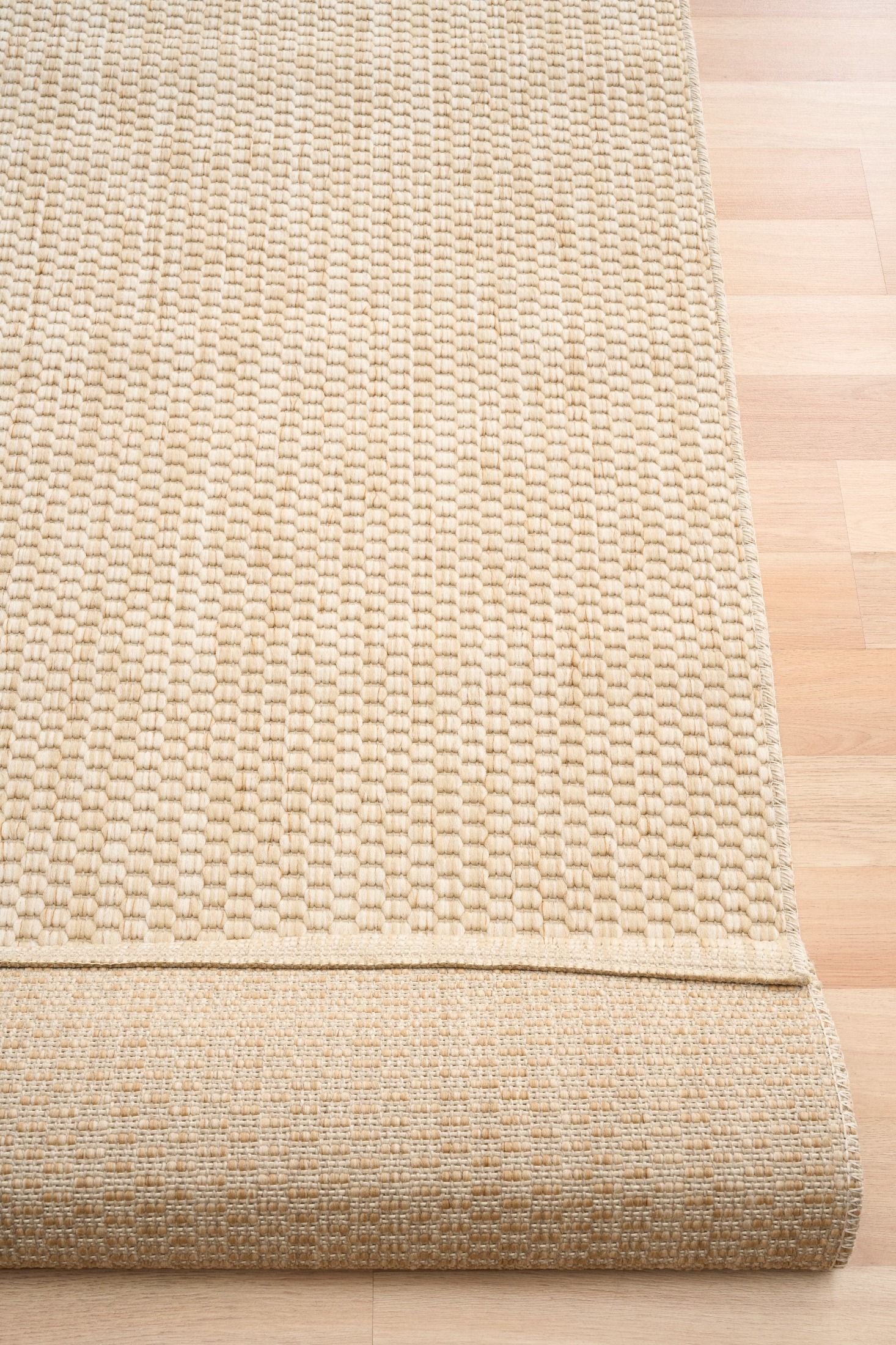 Barton Twill Cream indoor/outdoor rug featuring soft cream tones and a subtle textured pattern, power-loomed from UV-stabilised polypropylene for lasting durability. Colour cream. 3 sizes. Fold.