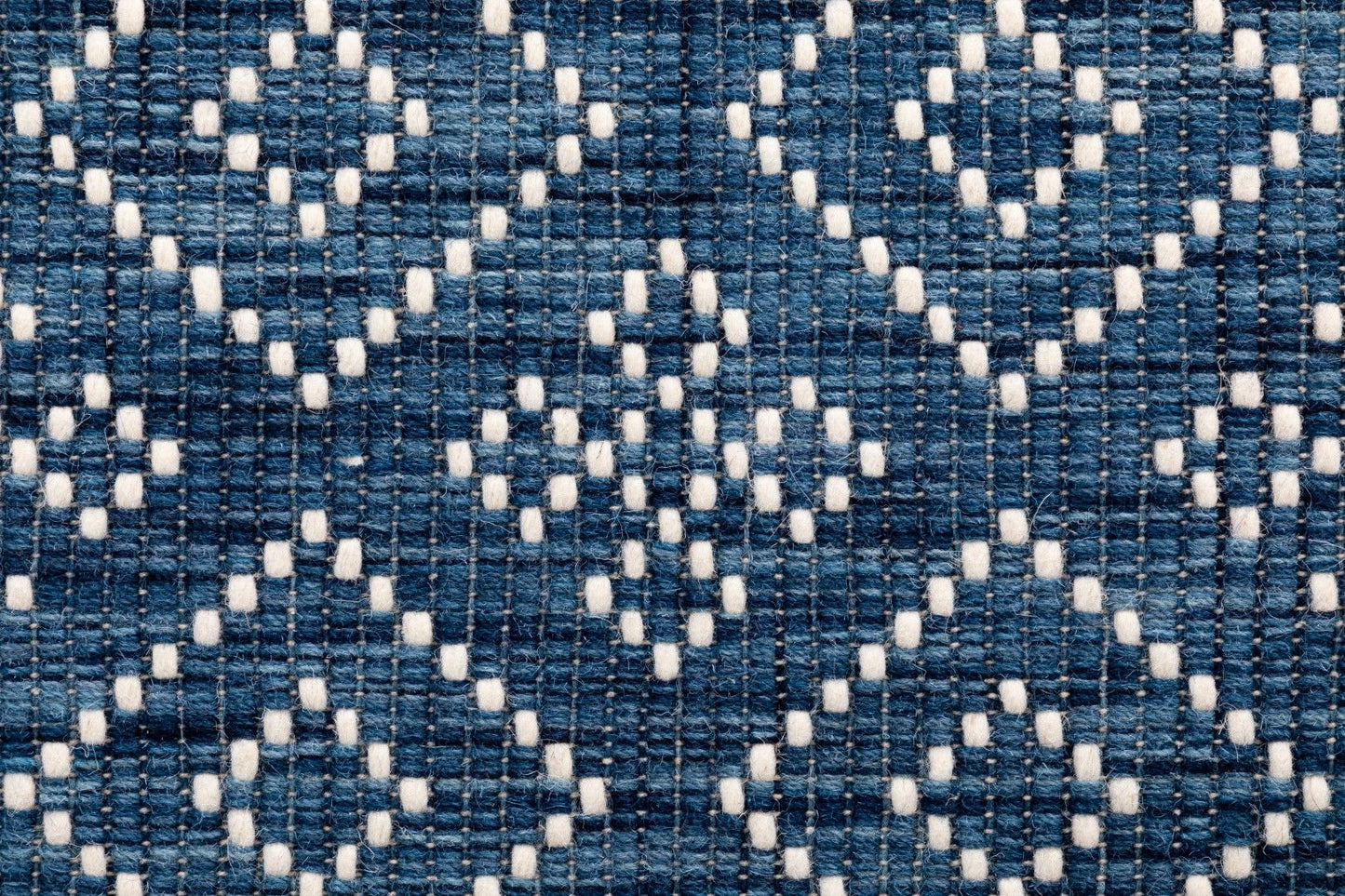 Bellevue Blue is a textured hand woven  wool and viscose rug.  Featuring a tribal diamond aztec design. Colours Blue with White Patterns. Sizes 200 X 290 and 300 X 400. Close.