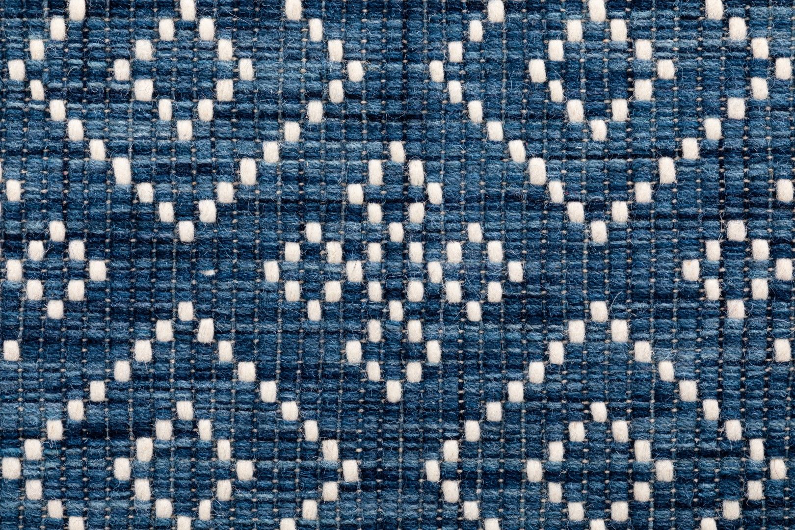 Bellevue Blue is a textured hand woven  wool and viscose rug.  Featuring a tribal diamond aztec design. Colours Blue with White Patterns. Sizes 200 X 290 and 300 X 400. Close.