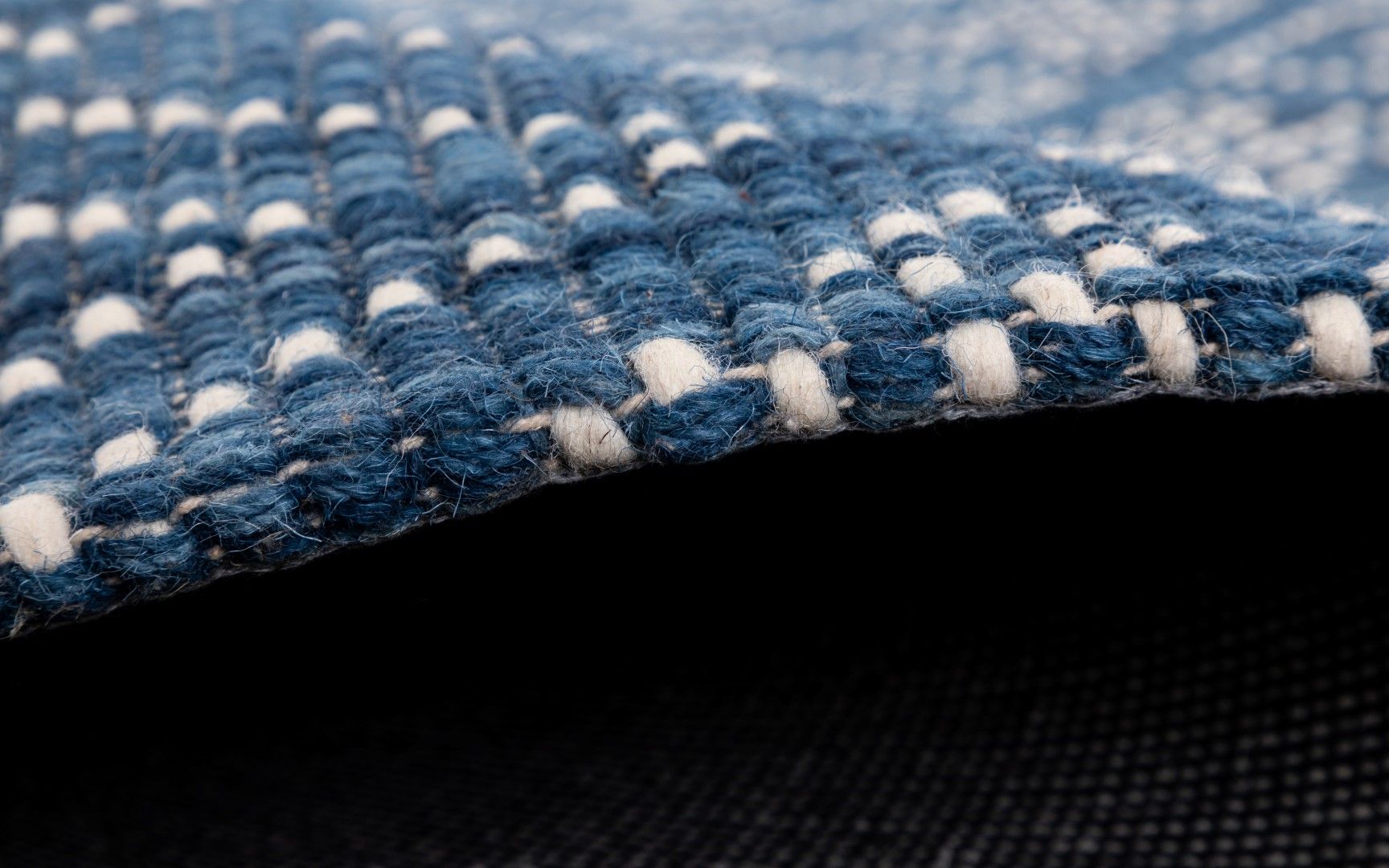 Bellevue Blue is a textured hand woven  wool and viscose rug.  Featuring a tribal diamond aztec design. Colours Blue with White Patterns. Sizes 200 X 290 and 300 X 400. Side.