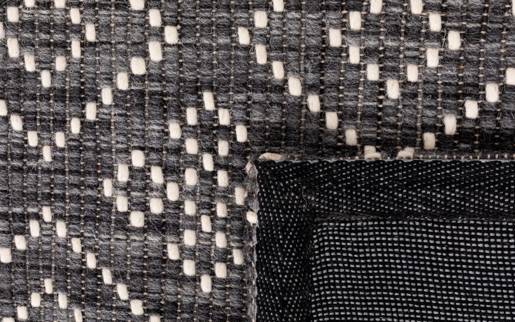 Bellevue Grey is a textured hand woven  wool and viscose rug.  Featuring a tribal diamond aztec design. Colours Grey with White Patterns. Sizes 155 X 225, 200 X 290 and 300 X 400. Fold.